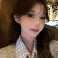 Detailed view of a sparkling heart flower zircon ear cuff worn by a model in warm light - Ear Bone Clip - Single Piece / Silver