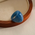 Detail view of a vintage blue marbled resin ring with a chunky round design - Blue