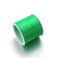 Flat elastic crystal string in emerald green on white spool for DIY jewelry making - Verdant