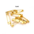 Detailed close-up of golden metal safety brooch pins with three holes for DIY jewelry - Medium / Gold