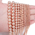 Macro detail of various sizes of rose gold hematite beads for DIY jewelry making - Approx 38cm Length, 4mm Diameter, 0.6mm Hole (Approx 95pcs) / Rose Gold