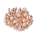 Macro view of rose gold frosted copper spacer beads with sandblasted texture for DIY jewelry - Rose Gold