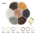 Macro view of 7-compartment floral storage box with assorted 6mm metal open jump rings - 1 Box / 6mm Mixed Colors