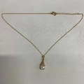 Elegant gold plated clavicle necklace featuring a zircon cone pendant and white pearl detail - Gold