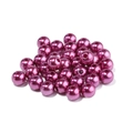 Close-up of bright purple ABS imitation pearls with holes for DIY jewelry making - Deep purple