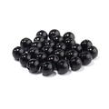 Detailed close-up of glossy black ABS imitation pearls with holes for DIY jewelry making - Black