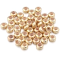 Detail van gouden platte schuifkralen met siliconen inzetstuk voor DIY-sieraden - 6mm (20 Stuks) / KC Goud