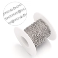Macro detail of stainless steel O-chain links on white plastic spool for jewelry making - Bead 2mm, Chain Width 1.5mm / Steel