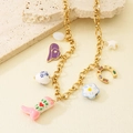 Detail view of vintage cowboy charms on a gold-plated stainless steel necklace chain - Necklace (KN298833-SXSJ)