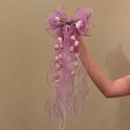 Close-up detail of a purple lily of the valley bow hair clip with long organza streamers. - Duckbill Clip (HH9856) / Single Piece / Pink