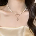 Elegant double-layered necklace featuring a pearl choker and flower pendant gold chain - Style 20