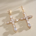 Macro view of luxurious cross-shaped earrings featuring sparkling cubic zirconia - Stud Pin Style / Gold
