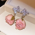 Detailed macro view of elegant zirconia butterfly studs featuring pink resin rosebud drops - Pink Preserved Flower Butterfly Style (48#) / Silver