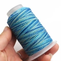 Close-up of multicolored gradient wax cord roll with metallic shine for DIY weaving - 6-Strand / C33 (Deep Light Blue Green)