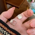 Close-up of irregular square glass earrings held by fingers showing fine silver finish - Irregular Square (HE32265) / Silver