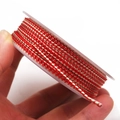 Detail of red and gold braided dragon pattern cord on a spool for DIY jewelry making - Approximately 1.2mm / Red Gold Style