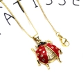 Macro detail of red ladybug pendant with zircon inlay on a gold-plated box chain - Red Ladybug Necklace (45cm)