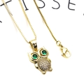Macro shot of owl pendant with green gemstone eyes and white cubic zirconia crystals - Owl Zircon Necklace (45cm)
