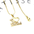 Macro shot of gold plated I Love MOM heart pendant with cubic zirconia and box chain - I Mom Heart Necklace (10+Necklace)