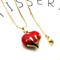 Detail view of red enamel heart pendant with gold lava flow on a fine box chain - Streamline Flame Heart Necklace (2+Necklace)