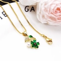 Detail of gold flower necklace with green petals, a pink zircon center and a white pearl - Green Pendant With Necklace