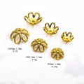 Macro detail of gold bead caps with twisted texture for DIY jewelry and necklaces - Twisted Hollow Style (H12MM)