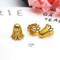 Macro detail of a 12x13mm gold trumpet bead cap with hollow petals for jewelry making - Flower Bud Hollow Style / 12x13mm