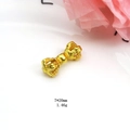 Detailed view of a 7x20mm gold-plated Vajra pestle pendant with fine textures - Style C Vajra Pestle