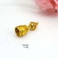 Macro detail of a 9x21mm gold plated Vajra bell pendant with Buddhist carvings - Style G Bell