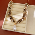 Detailed view of a vintage gold leaf wheat necklace with sparkling rhinestones and pearl. - Necklace (HE31877HN11501) / Antique Gold