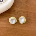 Macro detail of yellow and white enamel irregular stud earrings on a wooden surface - Irregular Stud Earrings / Yellow