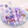 Mix of purple and pink acrylic DIY beads with cat shapes in a decorative glass tray - Purple