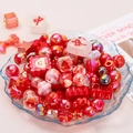 Vibrant red acrylic DIY bead kit with star and heart shapes in a blue glass bowl - Red