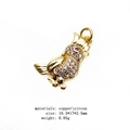 Detailed close-up of a gold bird pendant with micro-pave zircons and red gem eye - Owl Style (2#)