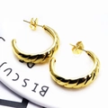 Detailed view of gold C-shaped earrings with spiral twisted metal texture and wave reflections - Twisted C-Shape (7)