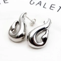 Macro detail of silver drop earrings with high-polish metallic finish and modern curves - Streamline Teardrop Stud Earrings (3) / Silver