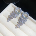 Macro detail of sparkly zircon teardrop pendant earrings in a white jewelry box - 34# (HE31465)