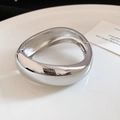 Close-up of a chunky polished silver metal bangle with an irregular organic shape - 4# Bracelet-Silver