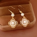 Detailed view of gold-plated clover earrings with pearls and zircons in a velvet box - Ear Hook - Gold
