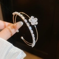 Detailed view of an elegant double-layered open bangle with a sparkling zircon flower - Four-petal Flower Style (2#) / Silver