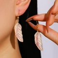 Detailed macro view of vintage gold-tone feather earrings with colorful gradient enamel texture - No.04 Lavender Cream Gradient Feather (X039)