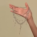 Detail view of multi-layered beaded necklace with elegant crystal-like drops and chains - Silver White