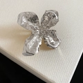 High-end detail view of an exaggerated silver hammered metal flower ring with texture - Ring (Size 6) / Silver