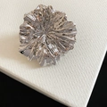Macro detail of an exaggerated silver metallic flower ring with a polished finish. - Ring (Size 8) / Silver