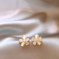 Detailed view of elegant flower stud earrings with cat-eye stones and cubic zirconia - Gold
