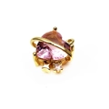 Macro detail of a heart-shaped pink crystal pendant with a gold Saturn ring accent - Heart Planet Style - Pink