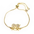 Detail of gold-plated adjustable bracelet with pavé zircon boy and girl charms - Side by Side Characters Style (6)