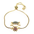 Detail of a gold-tone bolo bracelet with a zircon-inlaid girl charm and adjustable slider - Colorful Girl Style (8)