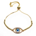 Close-up of golden evil eye bracelet with cubic zirconia and adjustable slider clasp - Oval Eye Style (1)