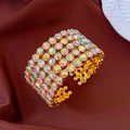 Detailed macro shot of a gold five-row cuff bracelet with shimmering AB rhinestones - Gold-AB Color